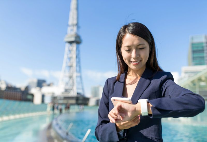 businesswoman-using-mobile-phone-and-smart-watch.jpg